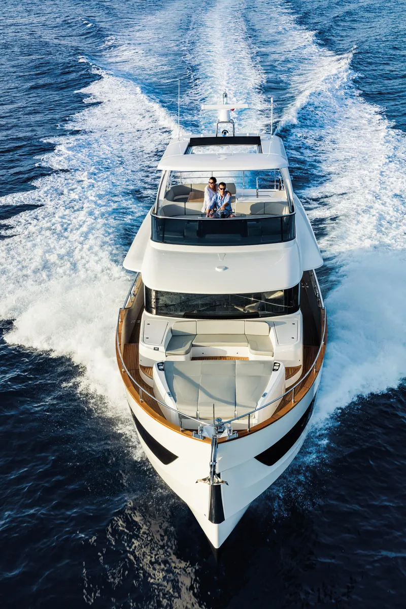 Slide: The Image of 2026 Absolute 58 Navetta yacht on calm ocean, rear view with open deck. - 2