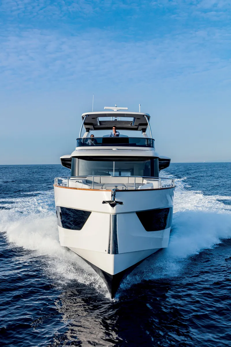 Slide: The Image of 2026 Absolute 58 Navetta yacht cruising on calm blue ocean waters. - 3