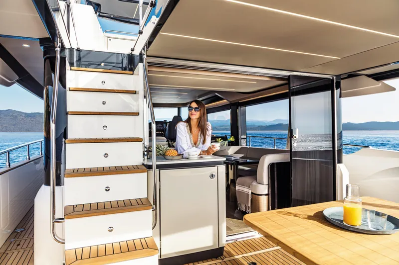 Slide: The Image of Luxurious interior of 2026 Absolute 58 Navetta yacht with modern kitchen and ocean view. - 13