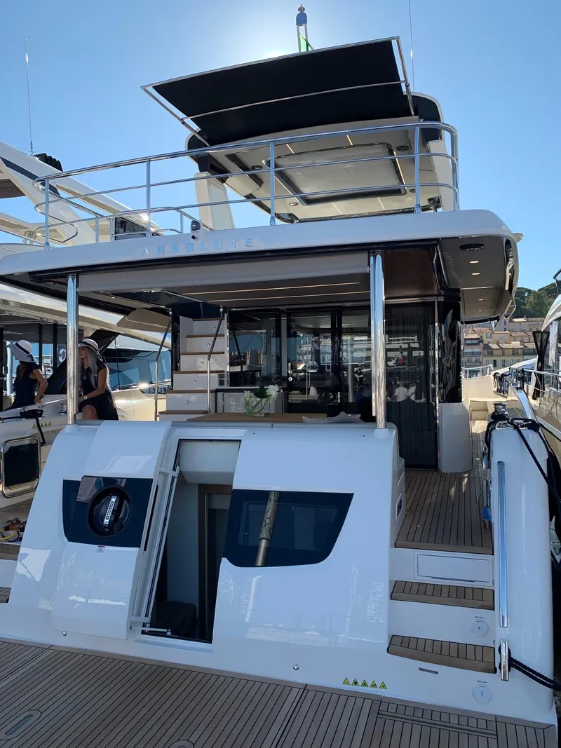 Slide: The Image of Luxurious Absolute 58 Navetta yacht interior, 2026 model, with elegant seating and ocean view. - 4