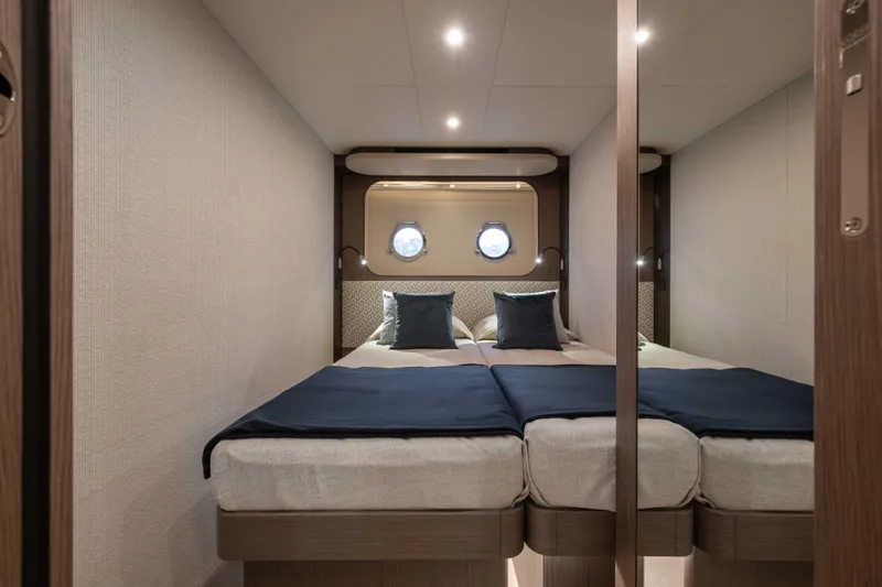 Slide: The Image of Luxurious cabin interior of 2026 Absolute Navetta 58 yacht with twin beds and porthole. - 50
