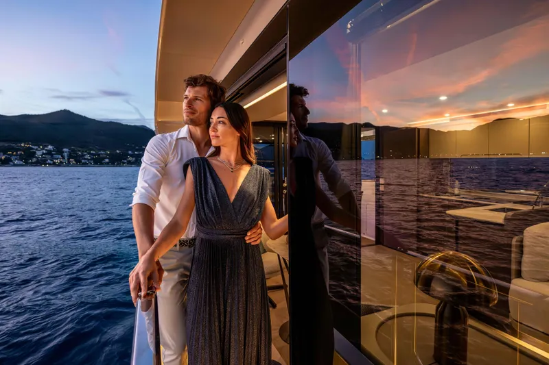 Slide: The Image of Couple enjoying sunset on Absolute Navetta 58 yacht, 2026 model, with scenic ocean view. - 55