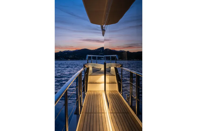 Slide: The Image of Luxurious Absolute Navetta 58 yacht deck at sunset, 2026 model, with serene ocean view. - 51
