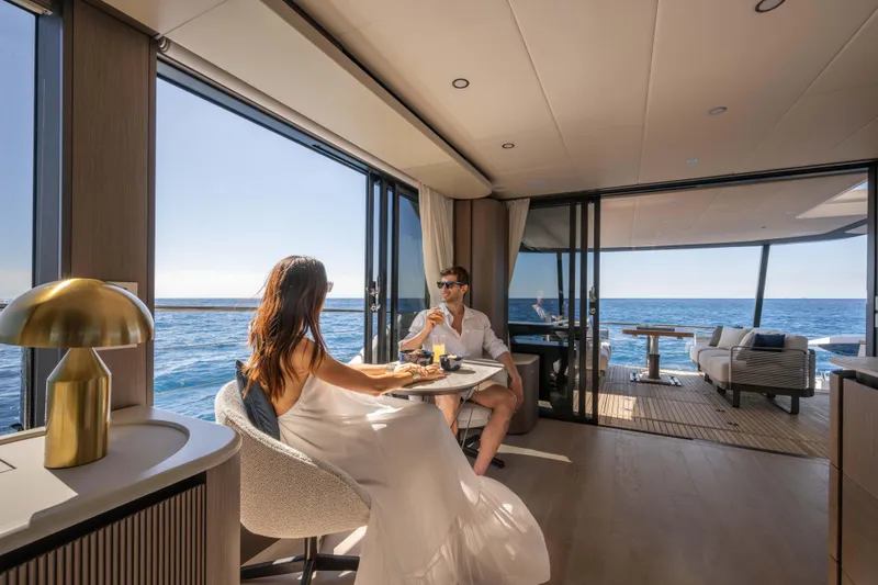 Slide: The Image of Couple enjoying a meal on the Absolute Navetta 58 yacht, 2026 model, with ocean view. - 36