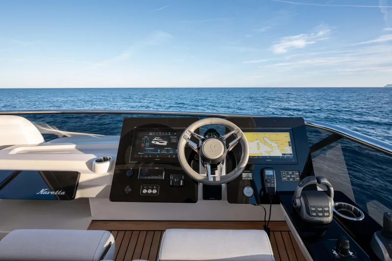 Slide: The Image of 2026 Absolute Navetta 58 yacht helm with advanced navigation systems, overlooking the ocean. - 22