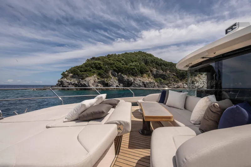Slide: The Image of Luxurious 2026 Absolute Navetta 58 yacht with elegant deck seating, scenic coastal backdrop. - 16