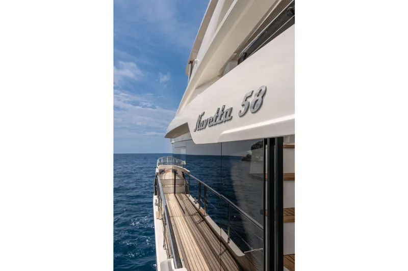 Slide: The Image of 2026 Absolute Navetta 58 yacht cruising on open sea under clear blue sky. - 15