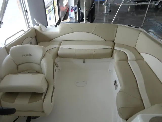 Slide: The Image of 2022 NauticStar 203DC Sport Deck interior with beige seating and spacious layout. - 3