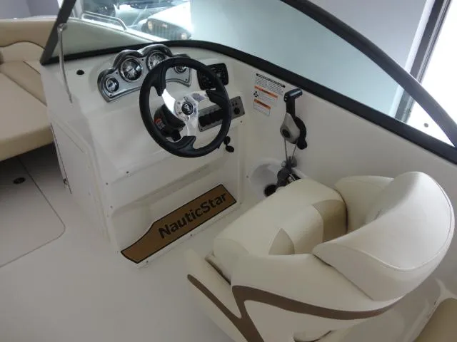 Slide: The Image of 2022 NauticStar 203DC Sport Deck boat interior with steering wheel and seating. - 4
