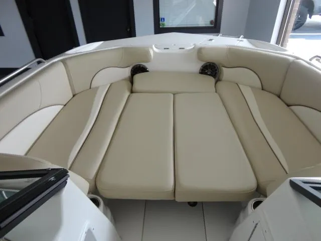 Slide: The Image of 2022 NauticStar 203DC Sport Deck interior with beige seating and spacious layout. - 5
