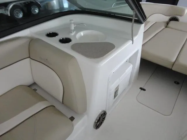 Slide: The Image of 2022 NauticStar 203DC Sport Deck interior with seating, sink, and cup holders. - 6