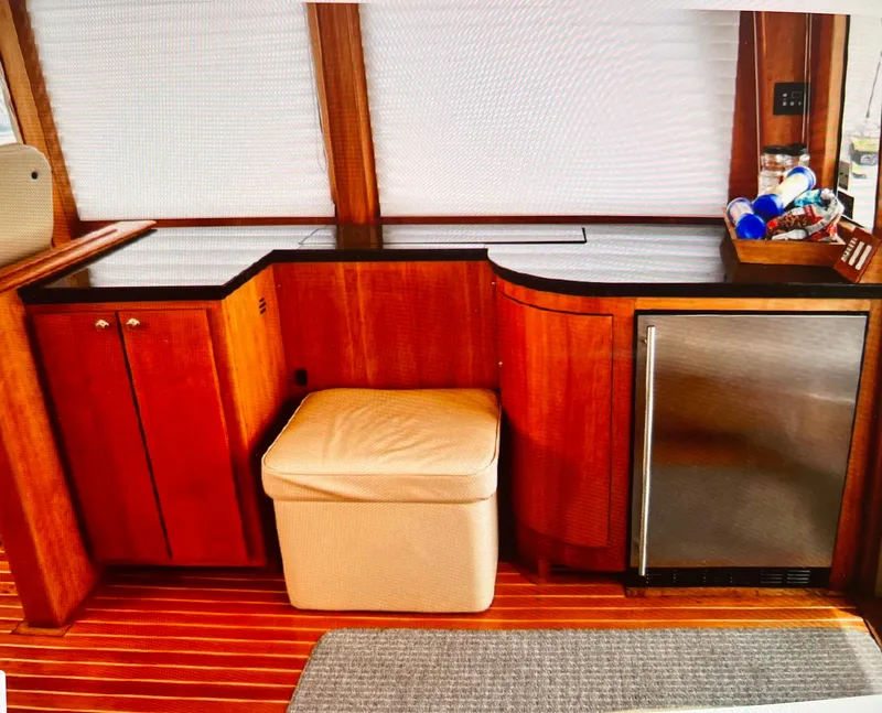 Slide: The Image of 2004 Legacy Downeast boat interior with wooden cabinetry and mini fridge. - 12