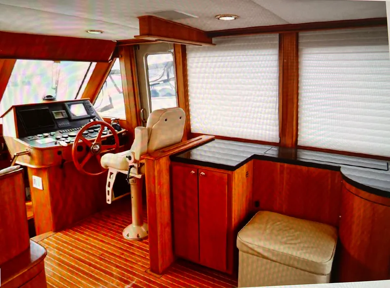 Slide: The Image of 2004 Legacy Downeast boat interior with wood finish and helm station. - 13