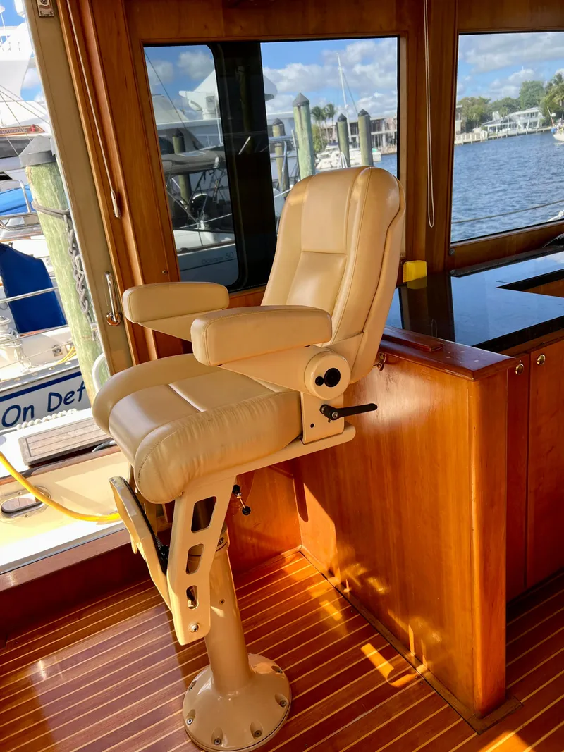 Slide: The Image of Captain's chair in 2004 Legacy Downeast boat, overlooking marina through large windows. - 17
