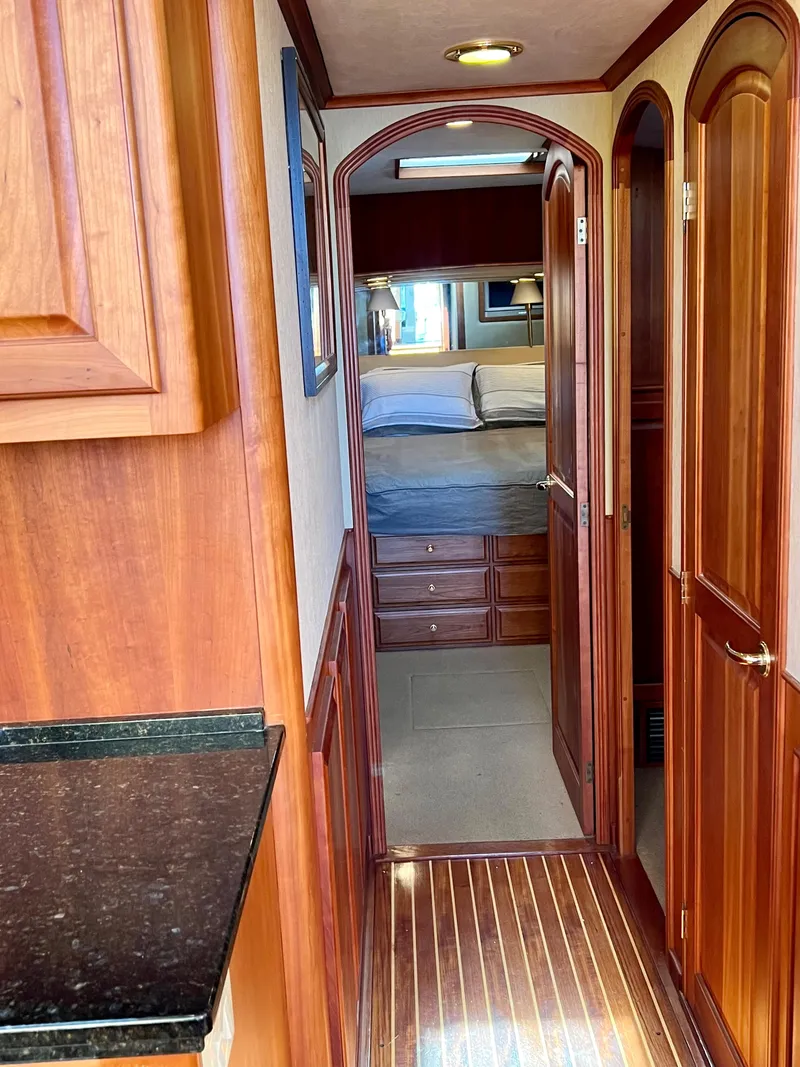 Slide: The Image of Interior of 2004 Legacy Downeast boat with wooden cabinetry and cozy bedroom. - 20
