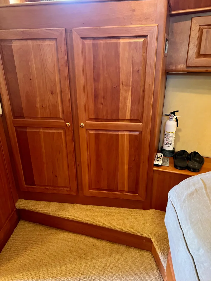 Slide: The Image of 2004 Legacy Downeast cabin interior with wooden cabinets and fire extinguisher. - 22