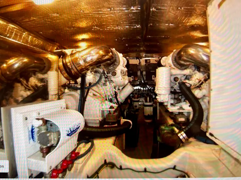 Slide: The Image of Engine room of a 2004 Legacy Downeast boat with visible machinery and pipes. - 25