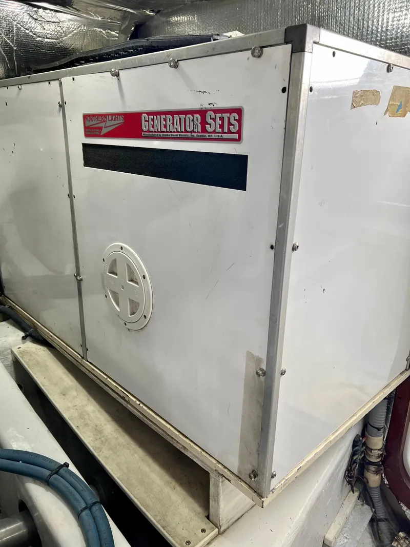 Slide: The Image of White generator set in a 2004 Legacy Downeast boat engine room. - 28