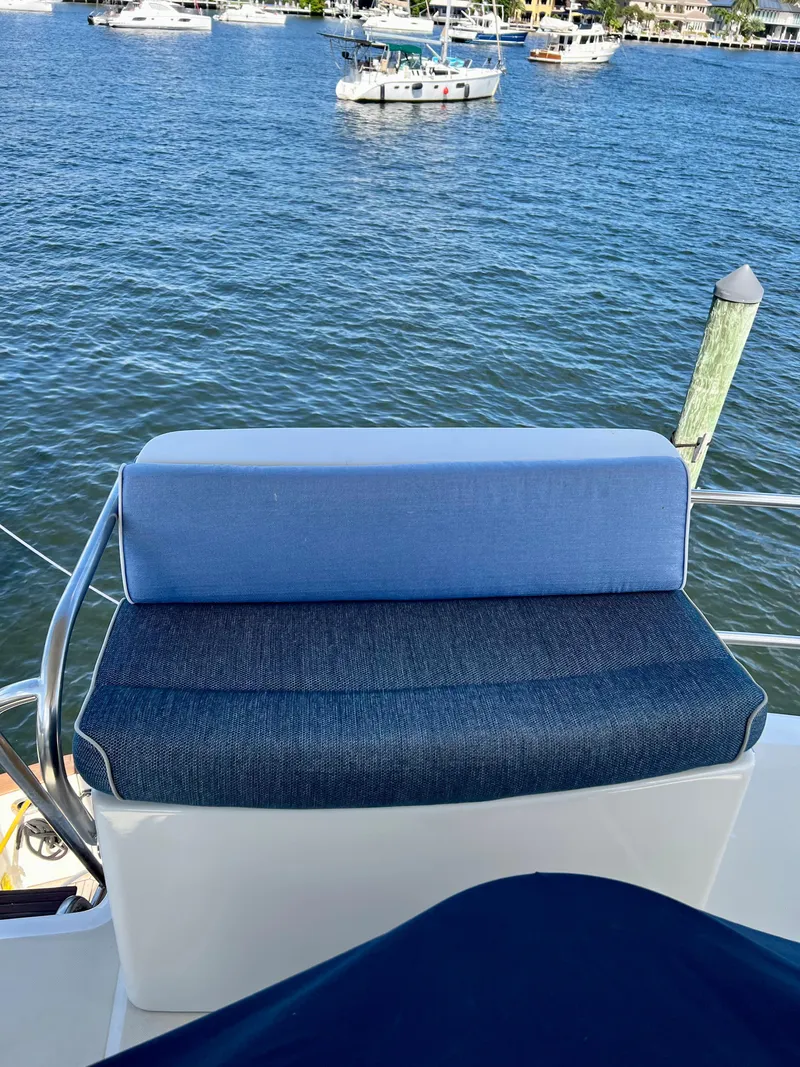 Slide: The Image of Blue cushioned seat on 2004 Legacy Downeast boat overlooking marina. - 30