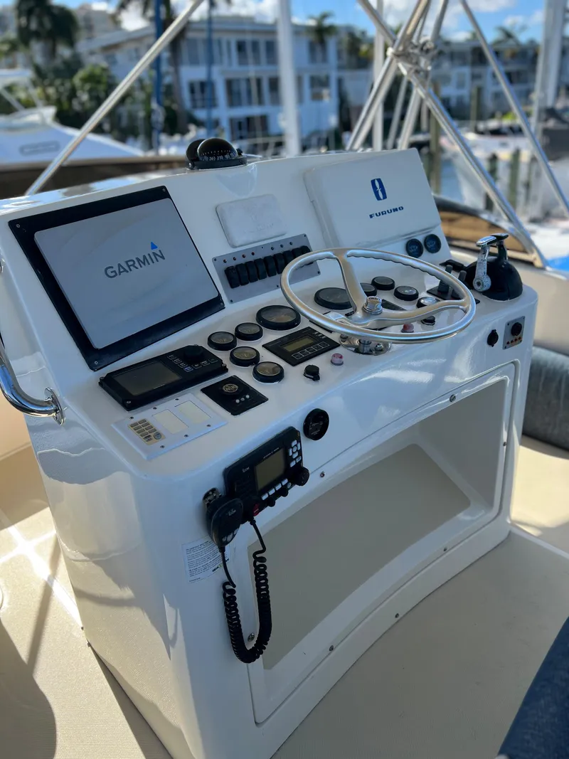 Slide: The Image of 2004 Legacy Downeast boat helm with Garmin navigation system and control panel. - 33