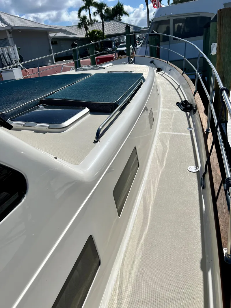 Slide: The Image of 2004 Legacy Downeast boat deck with railing, docked in marina. - 34