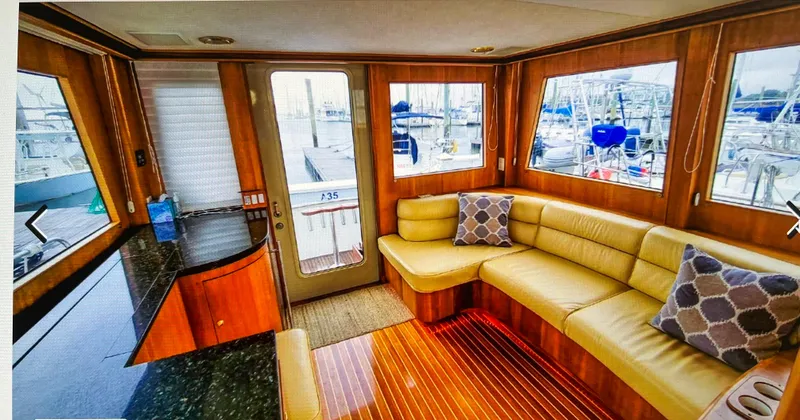 Slide: The Image of Luxurious 2004 Legacy Downeast yacht interior with leather seating and marina view. - 6