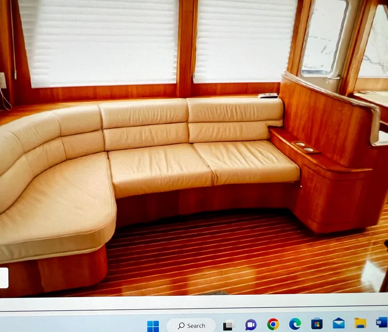 Slide: The Image of Luxurious 2004 Legacy Downeast yacht interior with leather seating and wooden flooring. - 7