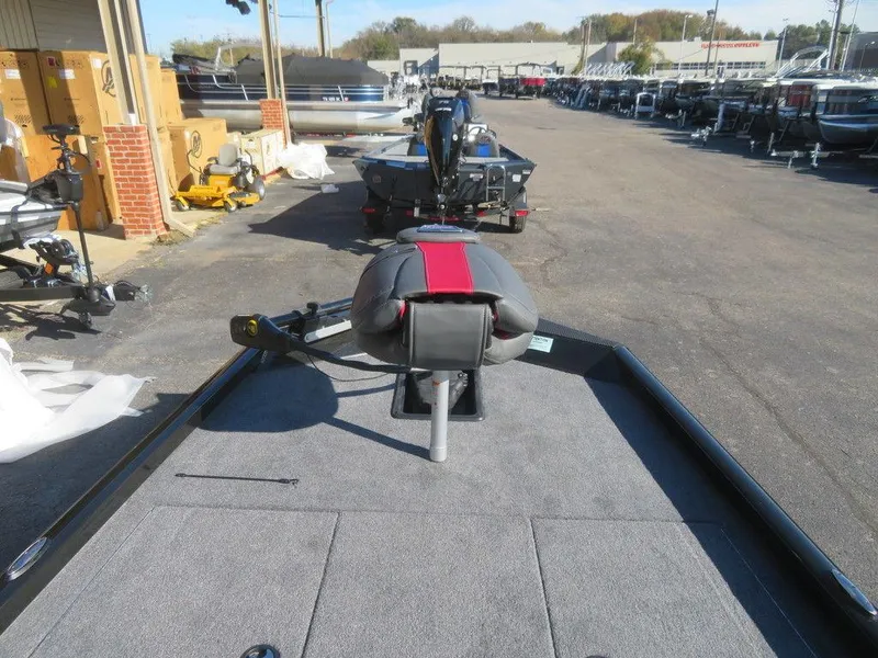 Slide: The Image of 2023 Ranger RT188 boat on display at dealership, featuring spacious deck and seating. - 6