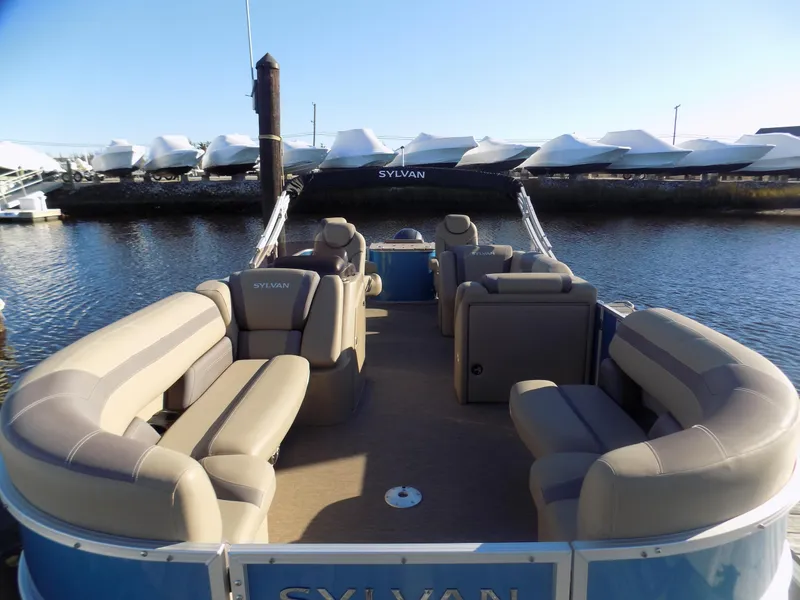 Slide: The Image of 2021 Sylvan L3 Party Fish pontoon boat with spacious seating on calm water. - 2
