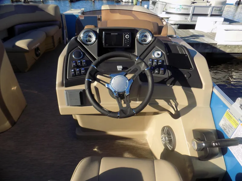 Slide: The Image of 2021 Sylvan L3 Party Fish boat dashboard with steering wheel and control panel. - 4