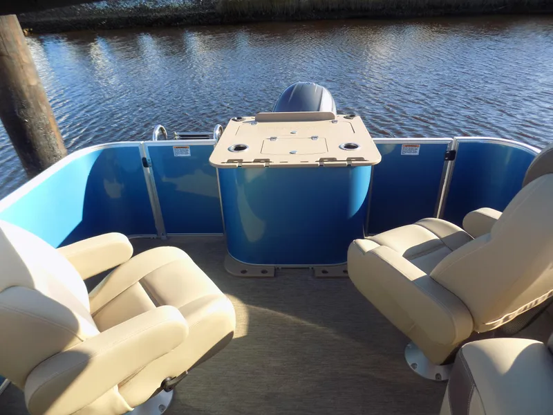 Slide: The Image of 2021 Sylvan L3 Party Fish boat interior with beige seats and blue paneling. - 8
