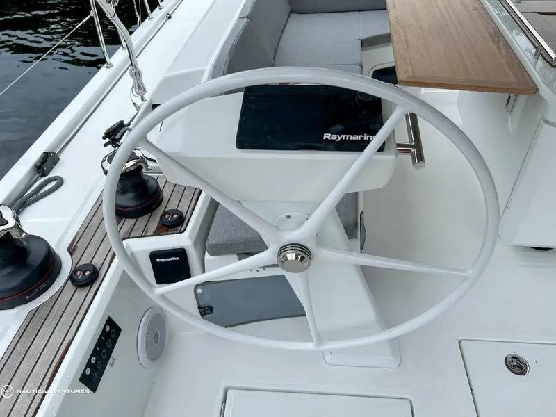 Slide: The Image of 2024 Beneteau Oceanis 51.1 yacht cockpit with steering wheel and Raymarine equipment. - 15