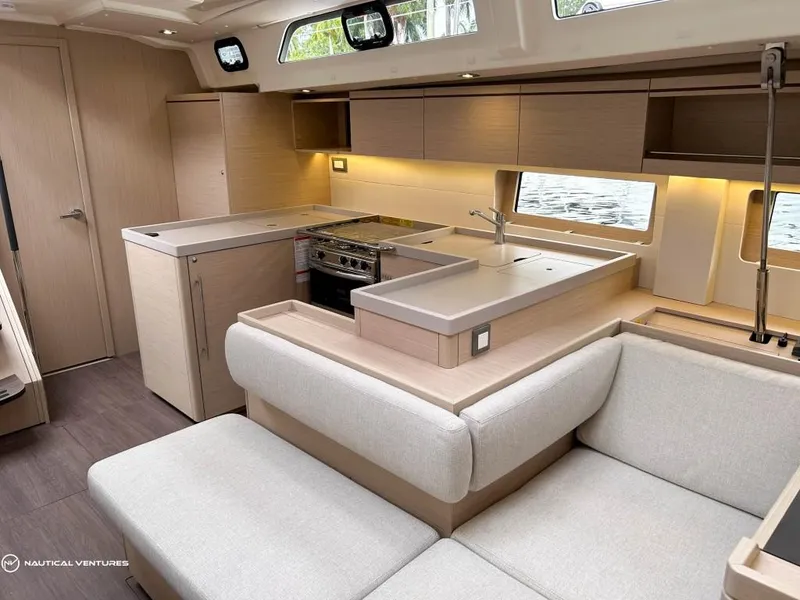 Slide: The Image of Luxurious interior of 2024 Beneteau Oceanis 51.1 yacht with modern kitchen and seating area. - 25