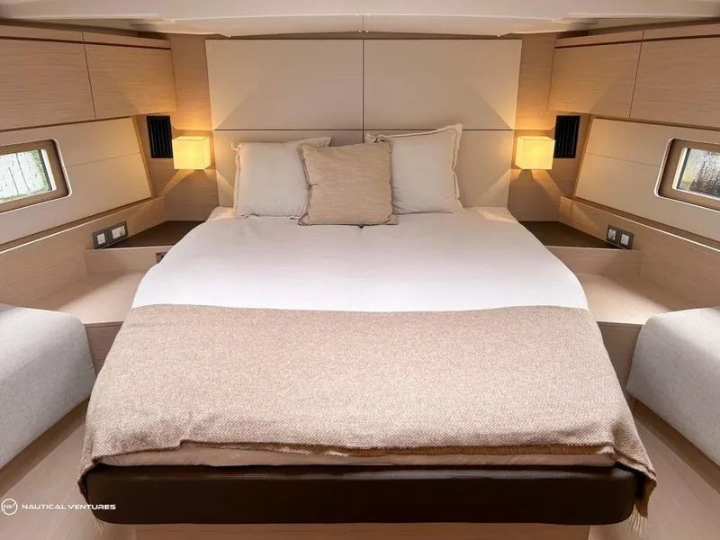 Slide: The Image of Luxurious bedroom interior of 2024 Beneteau Oceanis 51.1 yacht with cozy lighting. - 27