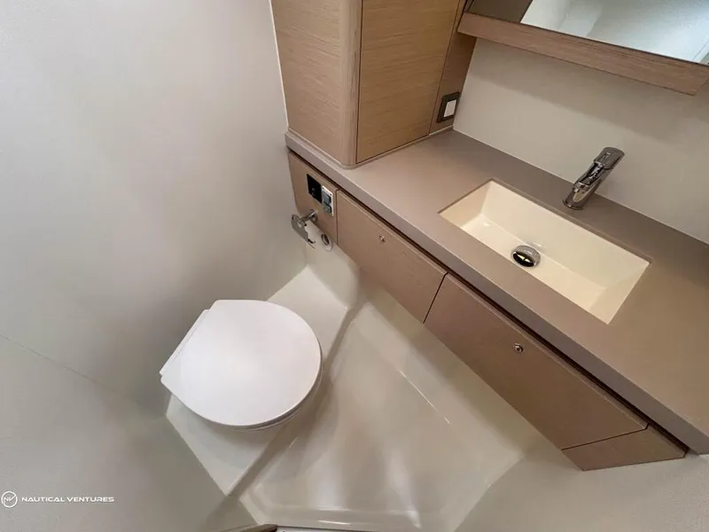 Slide: The Image of Modern bathroom in 2024 Beneteau Oceanis 51.1 yacht with sleek sink and toilet. - 30