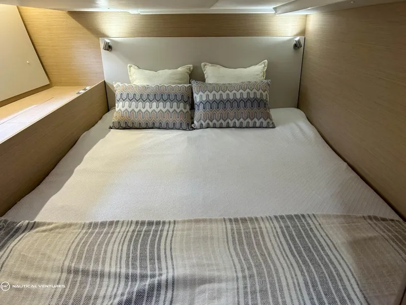Slide: The Image of Luxurious bedroom interior of 2024 Beneteau Oceanis 51.1 yacht with cozy bedding. - 35