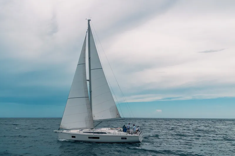 Slide: The Image of 2024 Beneteau Oceanis 51.1 sailing on open sea under a cloudy sky. - 45
