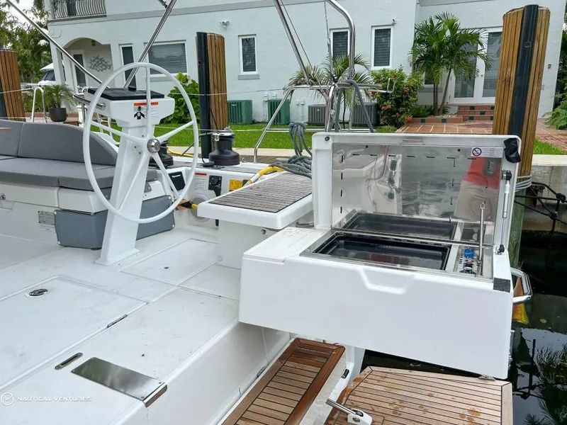 Slide: The Image of 2024 Beneteau Oceanis 51.1 yacht deck with outdoor grill and steering wheel. - 9