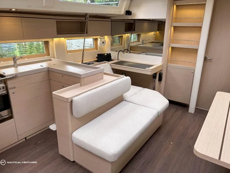 Slide: The Image of Luxurious interior of 2024 Beneteau Oceanis 51.1 yacht with modern kitchen and seating area. - 21