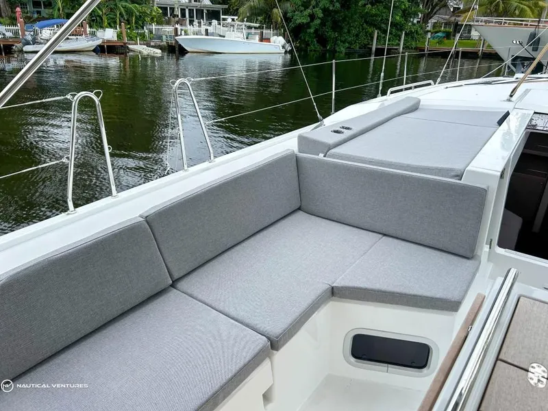 Slide: The Image of 2024 Beneteau Oceanis 51.1 yacht with spacious deck seating by the water. - 5