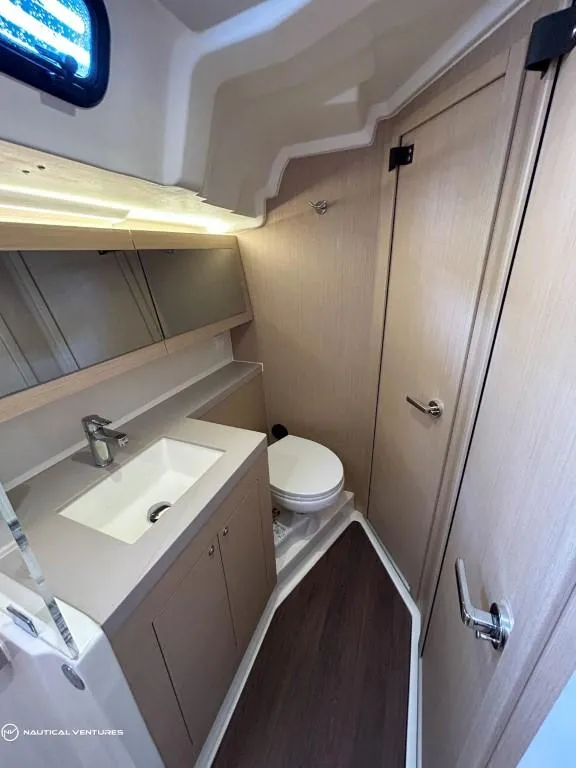 Slide: The Image of 2024 Beneteau Oceanis 51.1 yacht bathroom with modern fixtures and wood accents. - 37