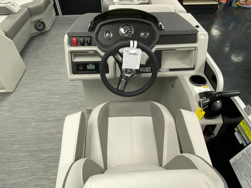 Slide: The Image of 2023 Godfrey Sweetwater 2286 SBX boat helm with steering wheel and control panel. - 12