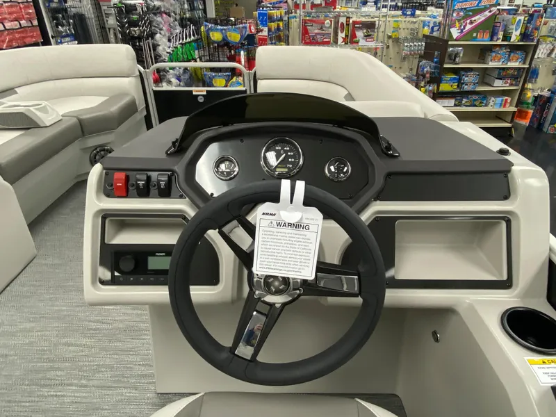 Slide: The Image of 2023 Godfrey Sweetwater 2286 SBX boat dashboard with steering wheel and controls. - 13
