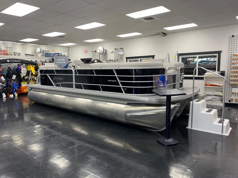 The Image of 2023 Godfrey Sweetwater 2286 SBX pontoon boat displayed in showroom. - 8