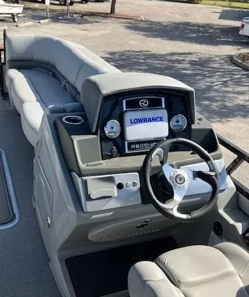 Slide: The Image of 2023 Regency 250 DL3 pontoon boat dashboard with Lowrance navigation system. - 2