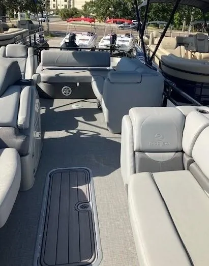 Slide: The Image of 2023 Regency 250 DL3 pontoon boat with spacious seating and modern design. - 4