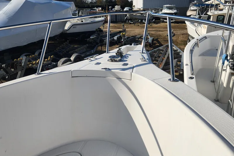 Slide: The Image of 2001 Cobia 274 Center Console boat deck, docked with other boats in the background. - 11