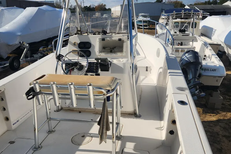 Slide: The Image of 2001 Cobia 274 Center Console boat with fishing rod holders and steering console. - 17
