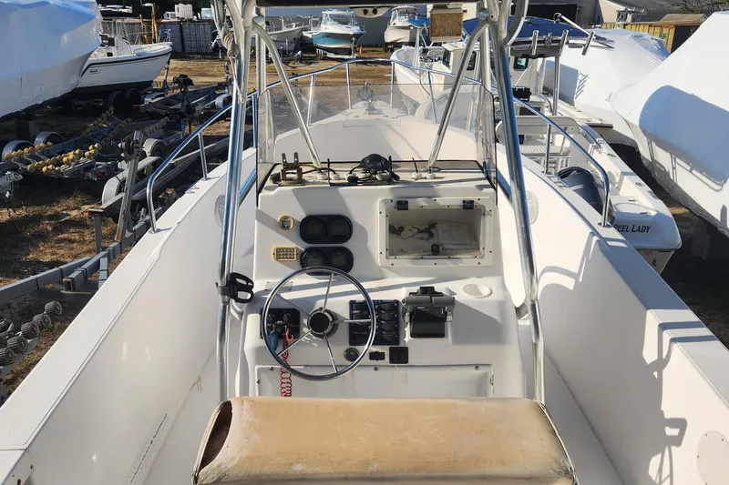 Slide: The Image of 2001 Cobia 274 Center Console boat interior with steering wheel and controls. - 19
