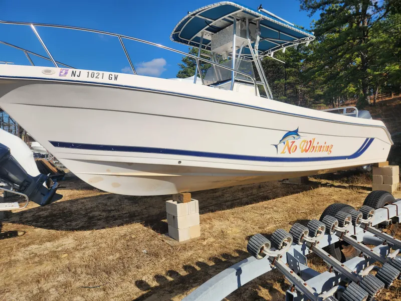 Slide: The Image of 2001 Cobia 274 Center Console boat on blocks, side view. - 4